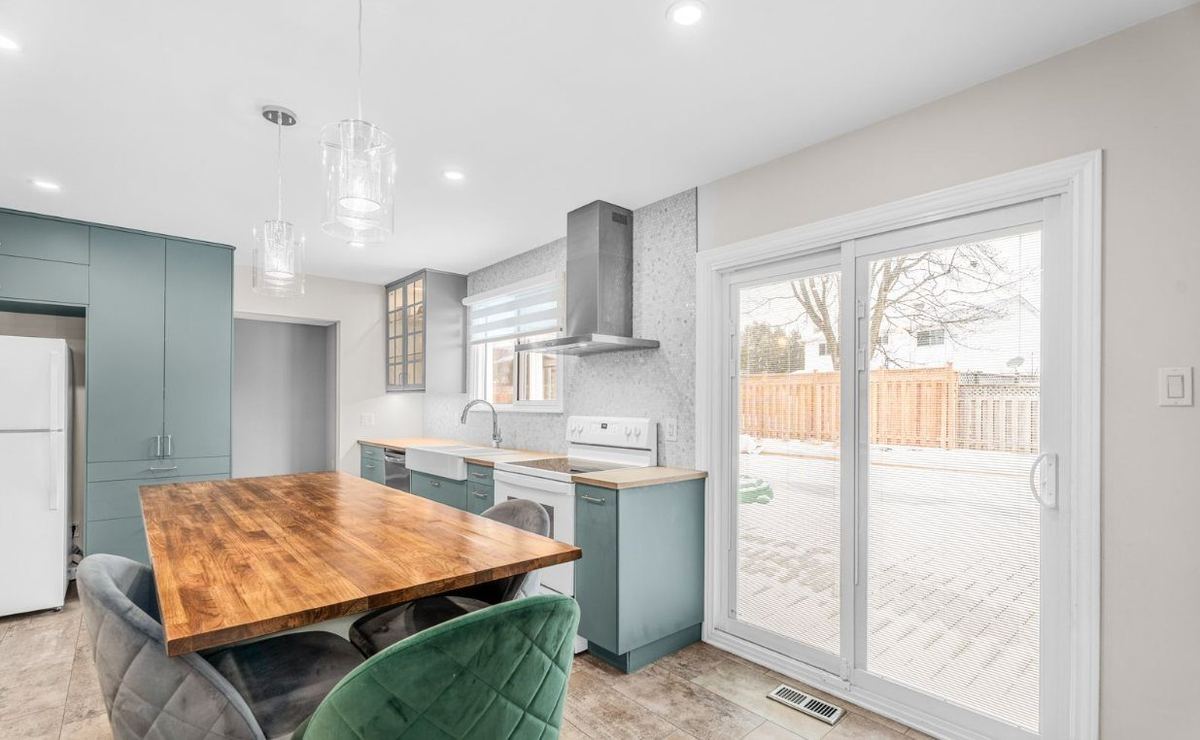Open kitchen and dining area with light walls, white trim and patio doors